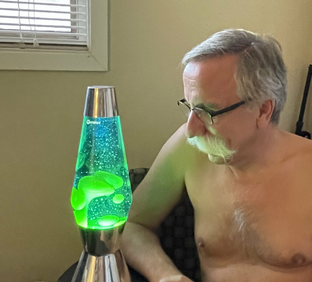 Naturist man with his lava lamp