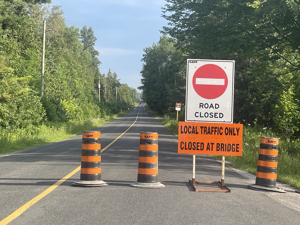 Signs on Kennedy Road explaining that the road is closed at the bridge